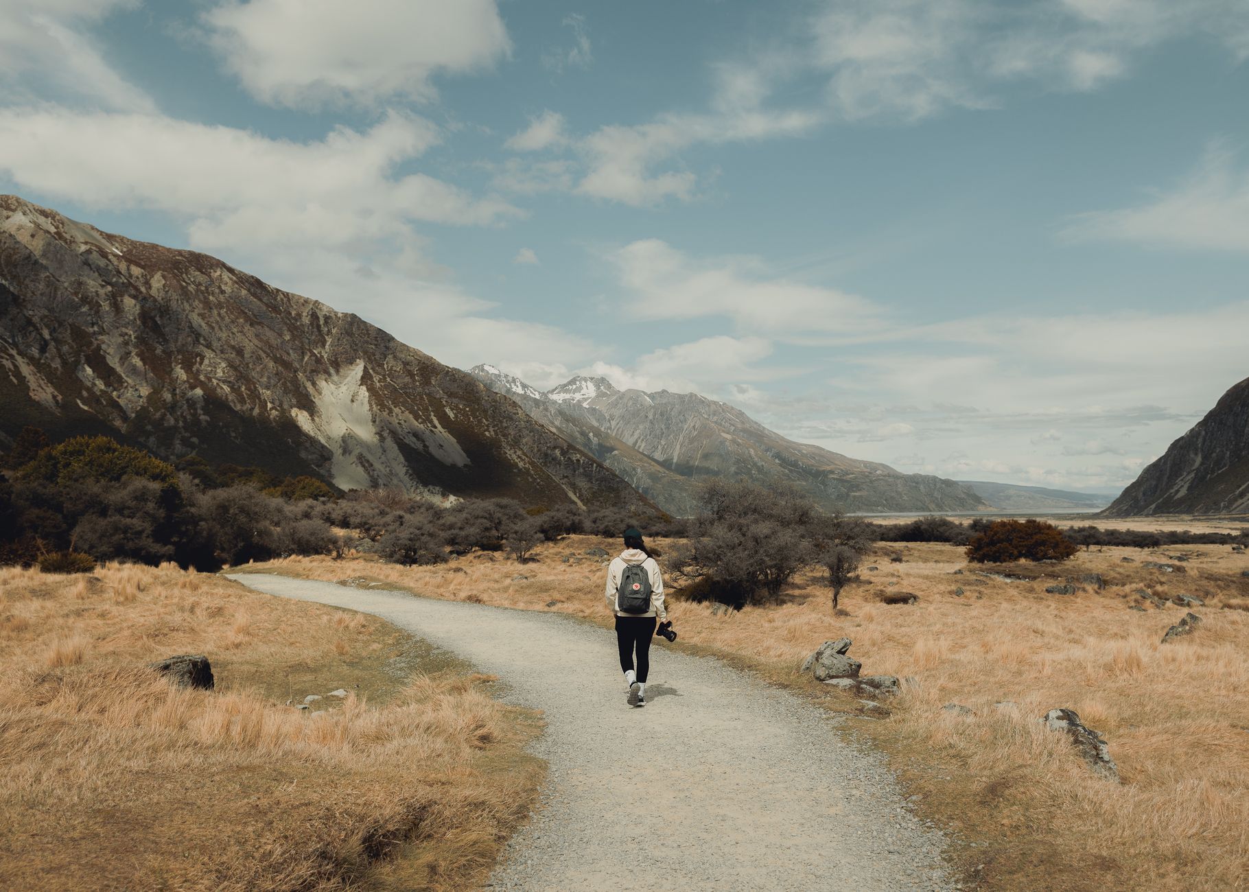 Hiker looking across majestic New Zealand valley