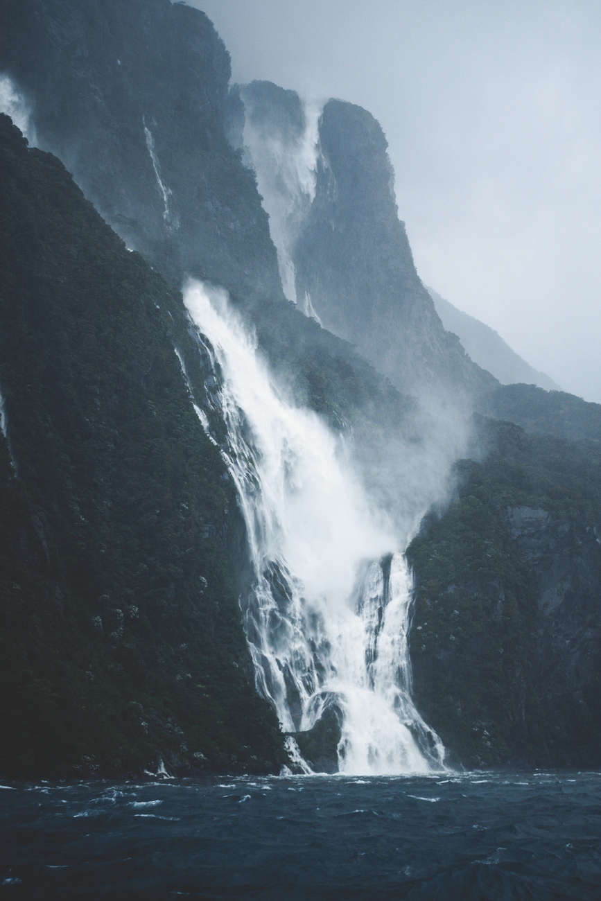Milford sound towering cliffs and tranquil water