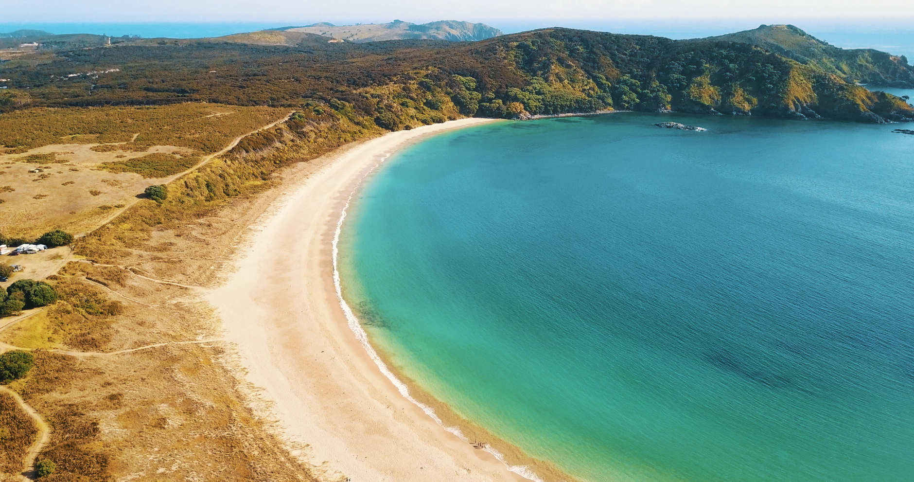 Lush coastal bay with turquoise sea in Northland New Zealand